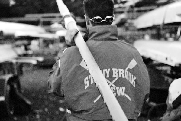 Black and White Photo of a SBU Crew member holding an oar.